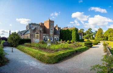 Fototapeta na wymiar Old house and castle with rose garden in Devon