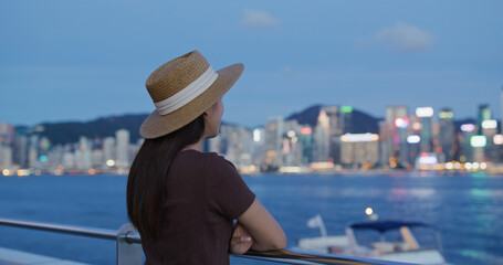 Woman enjoy the view of Hong Kong at sunset