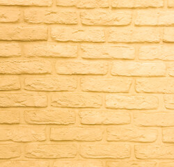 Yellow brick wall made of old brick.  Yellow background with texture.