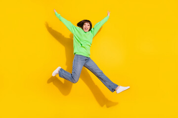 Fototapeta na wymiar Full length body size view of attractive cheerful girl jumping walking having fun isolated over bright yellow color background