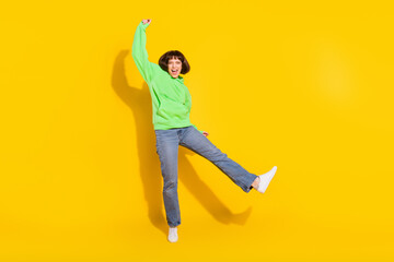 Fototapeta na wymiar Full length body size view of lovely cheerful girl rejoicing having fun isolated over bright yellow color background