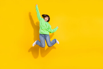 Full length body size view of pretty cheerful girl jumping rejoicing attainment isolated over bright yellow color background