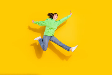 Fototapeta na wymiar Full body photo of happy young woman good mood raise hands active isolated on yellow color background