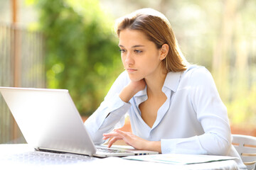 Businesswoman working online with laptop in terrace