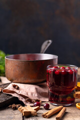 Hot mulled wine made of red wine, berries and oranges in a copper saucepan, decoration for New Year and Christmas