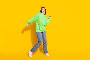 Fototapeta na wymiar Full length body size view of attractive cheerful girl dancing having fun pastime isolated over bright yellow color background