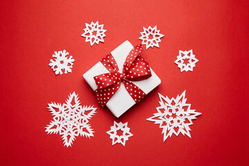 Christmas gift box with white snowflakes on red