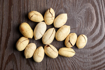 Pecan nuts into shell on wooden table