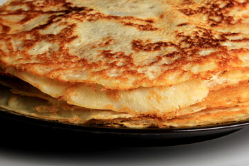 Pancakes on the black plate.Stack of tasty pancakes on white background. delicious pancakes in a stack 