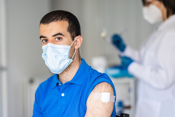 Fototapeta na wymiar Man receiving covid 19 vaccine jab at vaccination centre