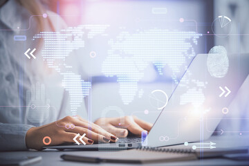 Double exposure of woman hands working on computer and world map hologram drawing. International technology business concept.
