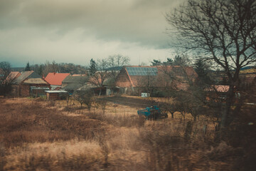 Residential houses on the roadside in europe in autumn landscape