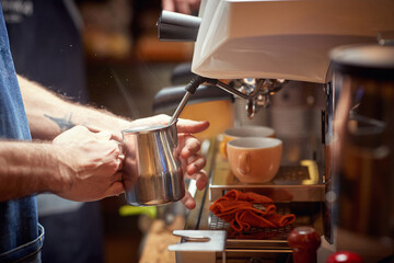 Fototapeta na wymiar Close up of a worker preparing coffee