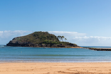island of lekeitio at low tide a sunny day with a blue sky and sea