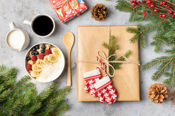 Christmas breakfast and gifts decorated with Christmas tree branches. Top view