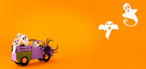 Happy halloween holiday concept. Halloween handmade paper decorations, spiders, ghosts in car on orange background. Halloween festival party, greeting card mockup with copy space