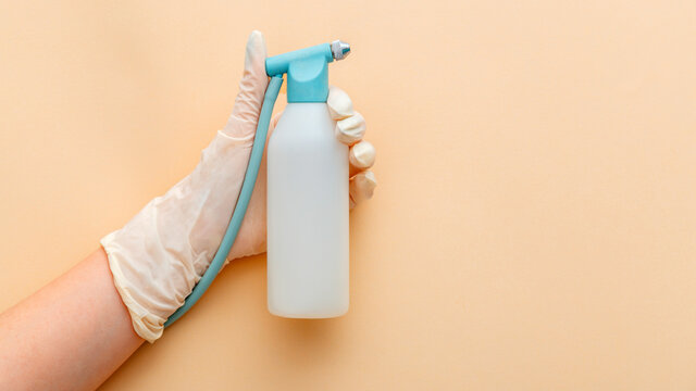 Liquid spray in female hand, hardware cosmetology, hydrodermabrasion and lifting devices. Dermatology cosmetology cosmetic combine tools for facial skin care health. Long web banner beige background
