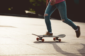 Fototapeta na wymiar Skateboarder skateboarding outdoors in city
