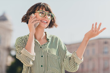 Photo of excited charming lady bob hairdo telephone communication wear glasses striped shirt urban...