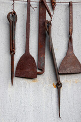 old rusty blacksmith tools on the wall

