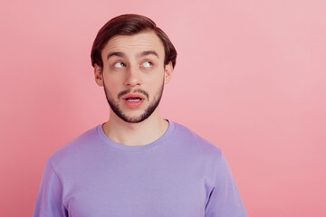 Photo of dreamy minded young man look empty space doubt imagine plan isolated on pastel color...