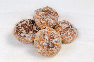 Glazed round thick treacle cookies on fabric napkin, close-up