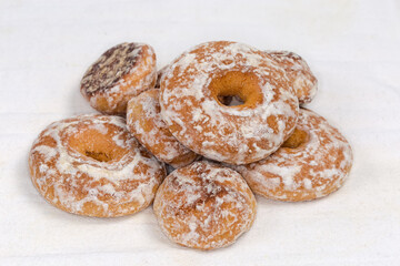 Glazed ring shaped and round spice cookies on fabric napkin