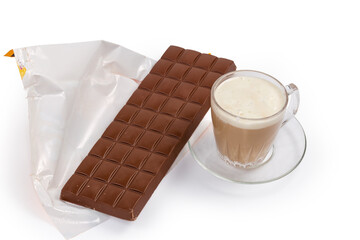 Bar of milk chocolate on opened wrapper and coffee drink