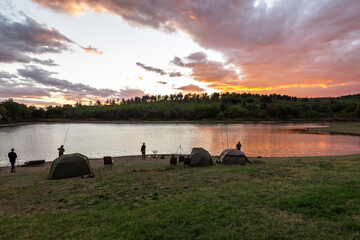Obraz na płótnie Canvas Fishing adventures. Carp fishing at sunset.