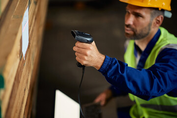 Close-up of worker uses bar code scanner while working at distribution warehouse.