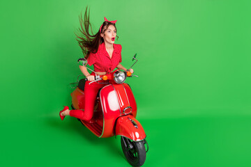 Profile photo of funky adventurous lady ride scooter wear dotted blouse high-heels isolated green...