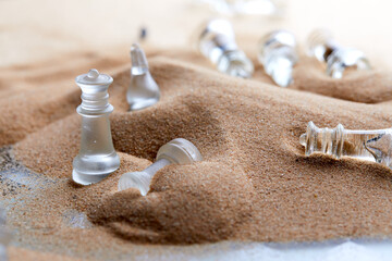 glass chess on the sand