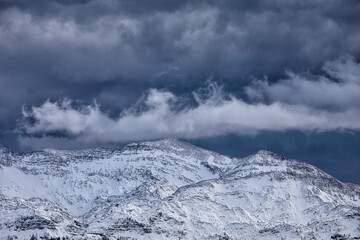 Fototapeta na wymiar stormy sky over snowy mountain
