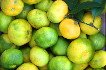 Wooden crate filled with fresh tangerines. Top view.