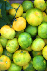 Wooden crate filled with fresh tangerines. Top view.