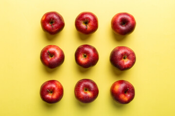 Many red apples on colored background, top view. Autumn pattern with fresh apple above view