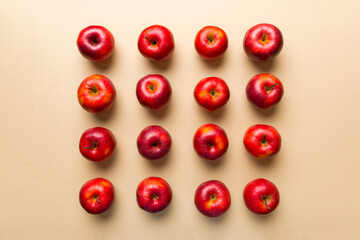 Many red apples on colored background, top view. Autumn pattern with fresh apple above view