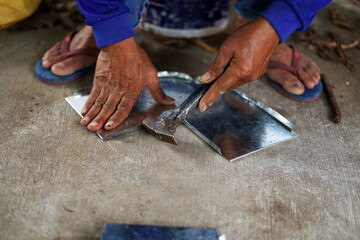 A contractor is assembling a piece of air duct to install for a ventilation system.
