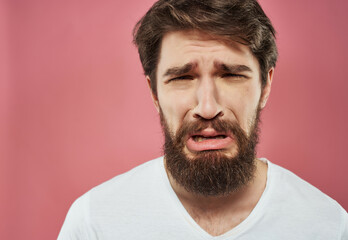 Fototapeta premium emotional man in a white t-shirt hand gestures anger close-up