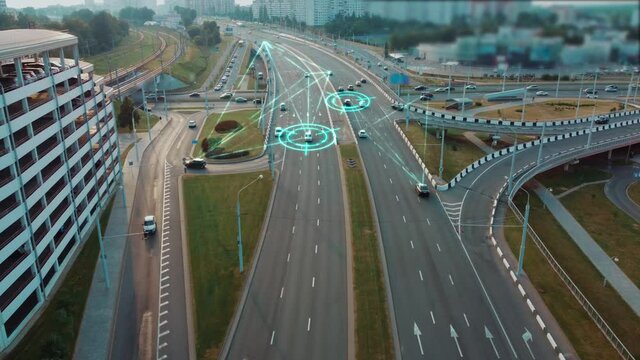 Concept of self-driving autonomous cars driving on a multi-level interchange in the city. HUD elements show interactions between machines. Autonomous Vehicles, Car Scan, IoT, Ai Logistic, GPS Tracking