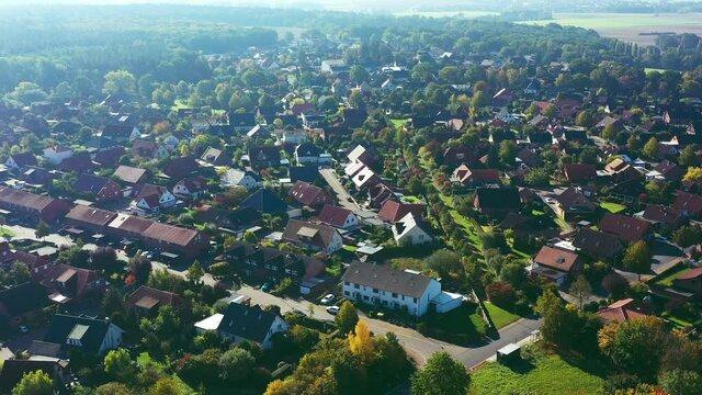 Aerial view of flight on the edge of a German suburb with streets and houses in a loose development from above