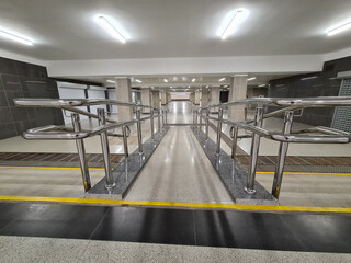 Handicapped ramp with metal railings in underpass background