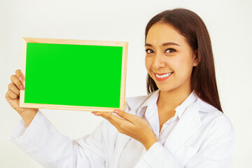 Portrait smile for you asian female doctor showing green plaque screen to insert text while working...