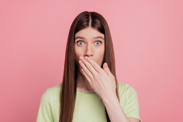 Portrait of astonished girl amazed shocked surprised close cover lips hand guilty isolated over pastel color background
