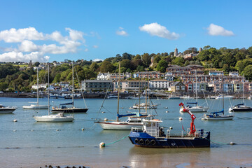 Fototapeta na wymiar Ships moored in Dartmouth harbour with Britannia Royal Naval College in the background, South Devon, England, United Kingdom
