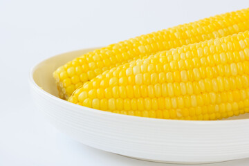 Close-up view two  boil corns in the plate