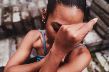 Young woman covering face with hands