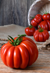 Ripe raw red tomatoes on rustic wooden table