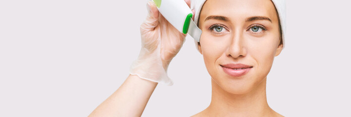 Ultrasound cosmetology scrubber. Face cavitation procedure. Salon skincare treatment. Professional...