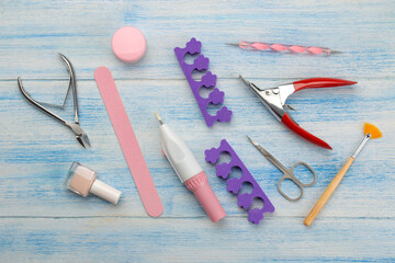 Various tools and things for manicure and pedicure on a blue background. view from above.